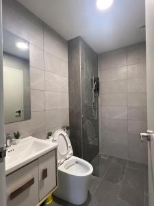 a bathroom with a toilet and a sink and a shower at Majestic Residence KLCC By AFA in Kuala Lumpur