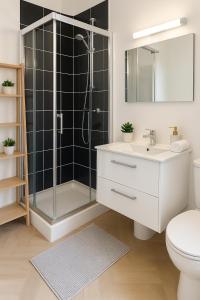 a bathroom with a shower and a toilet and a sink at Corderie in Rouen