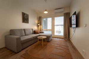a living room with a couch and a table at Snowflake XII Family rooms in Rovaniemi