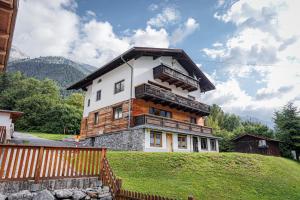 a house on top of a hill at Haus Diel - Premium Apartments mit Küche in Pettneu am Arlberg