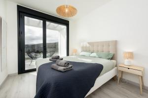 a bedroom with a large bed with towels on it at Golden View 2460 in Manilva +28 photos