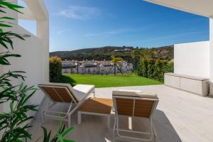 two chairs and a table on a patio with a view at Golden View 2460 in Manilva