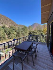 a patio with a table and chairs on a balcony at Top Ourika in Aghbalou +54 photos