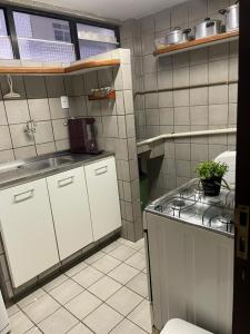 a small kitchen with a sink and a counter at Apt 202B- 2 quartos climatizado em Ponta de Campina in Cabedelo