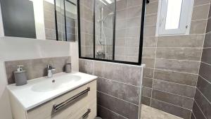 a bathroom with a sink and a mirror at Belle villa à 150m de la plage in Le Bois-Plage-en-Ré +9 photos