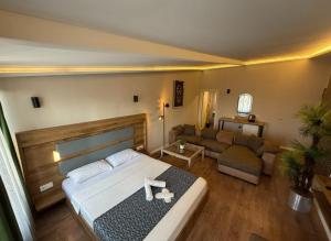a bedroom with a large bed and a couch at OTTO Boutique in Ankara