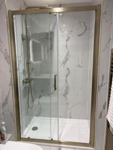 a shower with a glass door in a bathroom at The Old Bakehouse, central historical Beverley in Beverley +35 photos