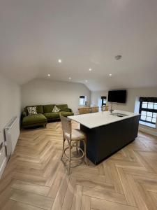 a kitchen and living room with a large island at The Old Bakehouse, central historical Beverley in Beverley
