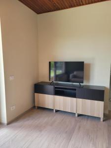 a living room with a flat screen tv on a wall at Casa Paolina in Premeno