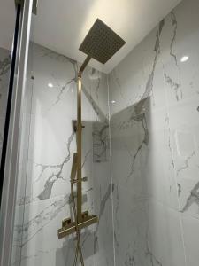 a bathroom with a shower with a light on the wall at The Old Bakehouse, central historical Beverley in Beverley