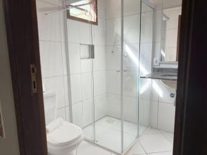 a bathroom with a glass shower with a toilet at Pousada Morada da Praia - Ubatuba -Praia Grande in Ubatuba +44 photos