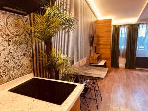 a room with a table and a palm tree at OTTO Boutique in Ankara