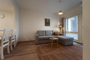 a living room with a couch and a table at Aurora suites with AIR CONDITIONING in Rovaniemi