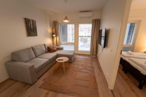 a living room with a couch and a bed at Aurora suites with AIR CONDITIONING in Rovaniemi