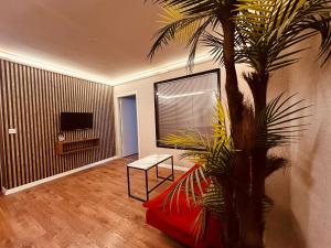 a living room with a palm tree and a television at OTTO Boutique in Ankara