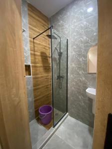 a shower with a glass door in a bathroom at DLA Lux Studio in Ikota, Lagos in Lekki