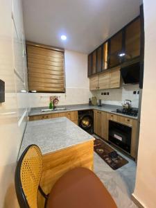 a kitchen with wooden cabinets and a counter top at DLA Lux Studio in Ikota, Lagos in Lekki +56 photos