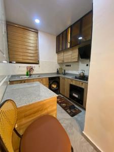 a kitchen with a counter and a table and chairs at DLA Lux Studio in Ikota, Lagos in Lekki