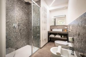 a bathroom with a shower and a toilet and a sink at Holiday Apartments Campoverde in Salò +53 photos
