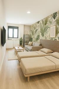 a living room with three beds and a couch at Apartamento estudio 101 in El Tablero