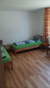a bedroom with a bed and two chairs in it at Möblierte Zimmer mit Gemeinschaftsküchen und Wohnungen in Thüringen Wald in Ohrdruf