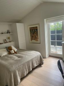 a bedroom with a bed with a teddy bear on it at Summerhouse Denmark in Tisvildeleje 700 m walk from beach in Tisvilde