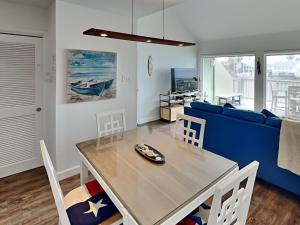 a dining room with a table and a blue couch at Sunset Water View in Padre Island
