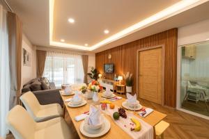 a living room with a dining table and a living room at VivaDeva , Pool Villa In Nimman 4BR Near MAYA MALL in Chiang Mai
