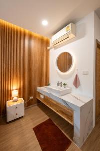 a bathroom with a sink and a mirror at VivaDeva , Pool Villa In Nimman 4BR Near MAYA MALL in Chiang Mai