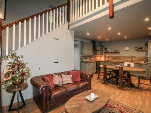 a living room with a couch and a table at Robins Rest at The Lodge in McGrathʼs Cross Roads +11 photos