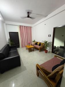a living room with a couch and a table at Grazioso Home Stay in Guwahati