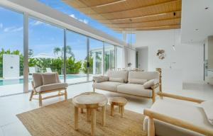 a living room with a couch and a table at Asherah NEW 3BR Villa Luxury Poolside Paradise in Bang Tao Beach