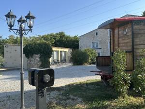 a security light next to a house with a building at Le Moulin de Sonnailles in Cabriès