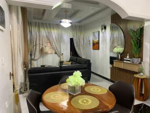 a living room with a table and a couch at Azure Villa Suites Apart Hotel in Limbe +120 photos