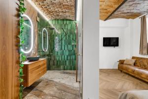 a bathroom with a green shower with a couch at The Magnificent Urban Hideaway in Vinohrady