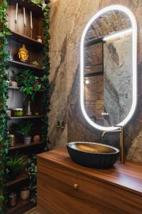 a bathroom with a black sink and a mirror at The Magnificent Urban Hideaway in Vinohrady