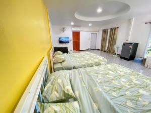 Postel nebo postele na pokoji v ubytování บ้านไออรุณในฝัน ที่พักเมืองเลย วิวเขา