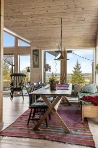 a wooden dining room with a table and chairs at Family Cabin With Views Over Hadeland in Roa +31 photos