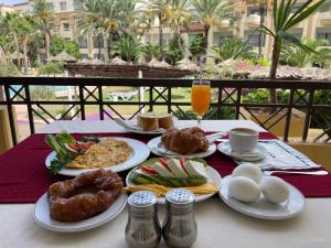 a table with plates of food and eggs on it at Marina Palace in Hammamet