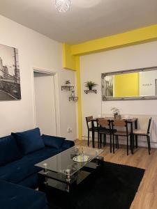 a living room with a blue couch and a table at Good Heart in Birmingham