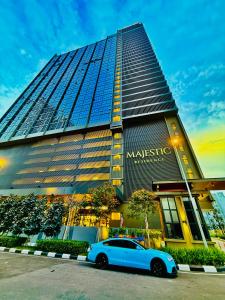 a blue car parked in front of a building at Majestic Residence KLCC By AFA in Kuala Lumpur