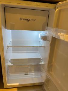 an empty refrigerator with its door open and its drawer at Good Heart in Birmingham +15 photos