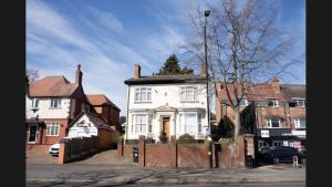 a white house with a tree on top of it at Good Heart in Birmingham
