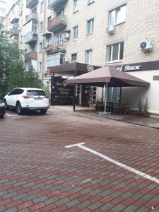 a car parked in a parking lot next to a building at Hotel Voyage in Kharkiv