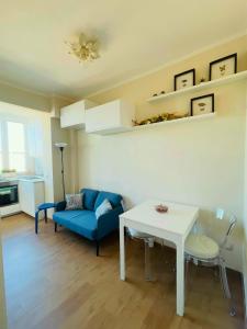 a living room with a blue couch and a table at B33 A natural tilt for beauty in Pisa