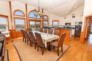a kitchen and dining room with a table and chairs at SEMI-OCEANFRONT, Wild Horses, Private Pool-4x2238, Finally Here in Knotts Island