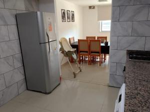 a kitchen with a refrigerator and a table with chairs at Galan in Paraná