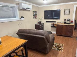 a living room with a couch and a flat screen tv at The Fishing Hole #4 Near Town in Bryson City