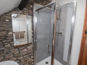 a shower in a bathroom with a stone wall at Arian in Aber-nant +16 photos