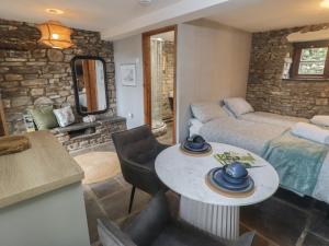 a living room with a table and a couch at Gwyn Studio in Aber-nant